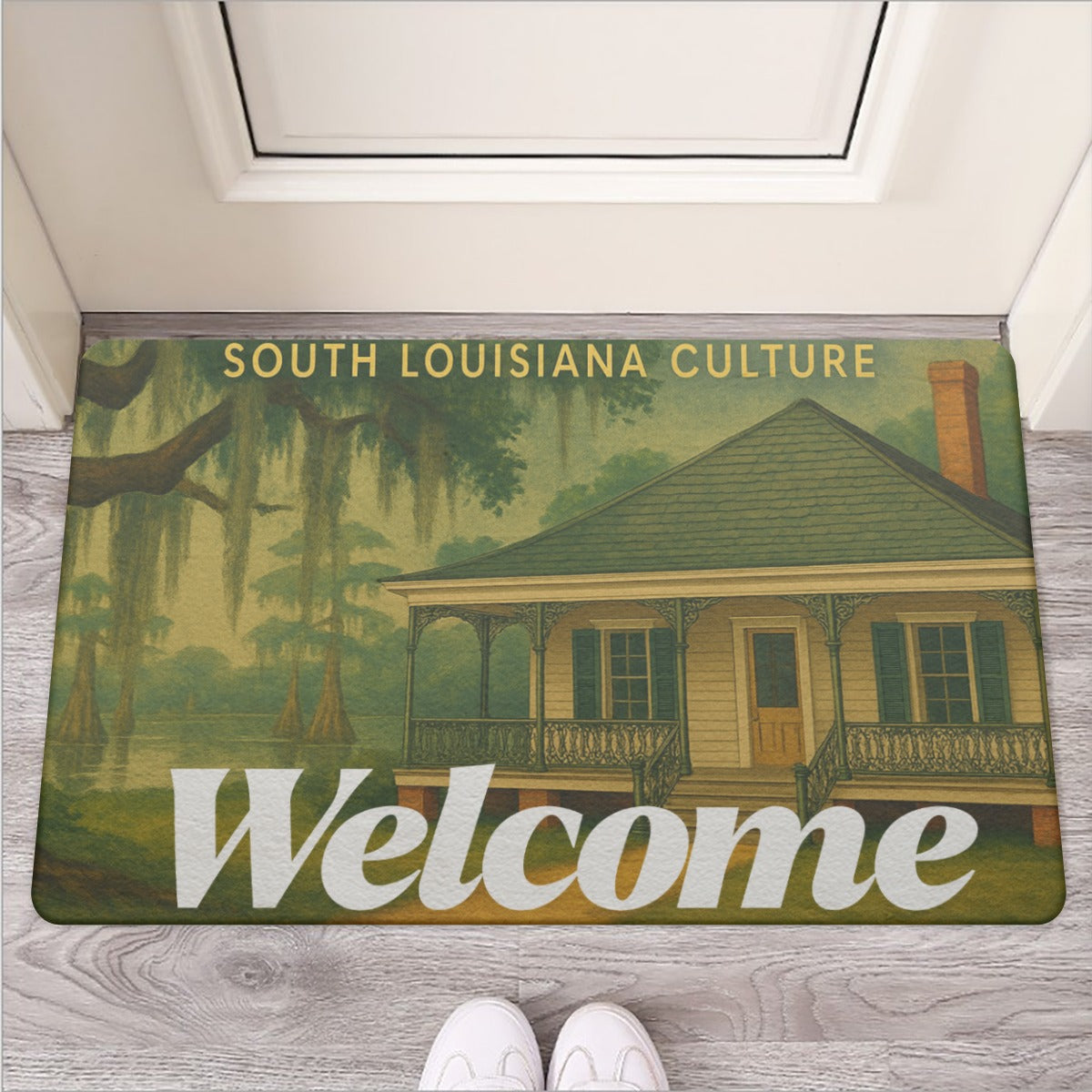 Doormat with a design of a house and trees, featuring the text 'South Louisiana Culture Welcome'.